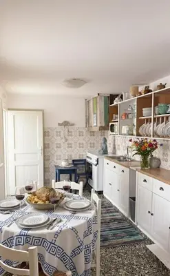 a kitchen with a table with a plate of food on it at Heritage House Malonas in Malona Village