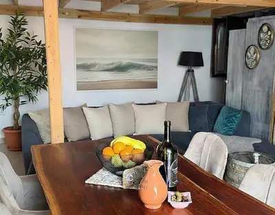 a table with a bowl of fruit and a bottle of wine at Heritage House Malonas in Malona Village