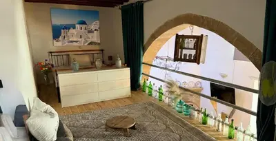 a living room with an archway in a room with a fireplace at Heritage House Malonas in Malona Village