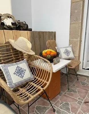 a table and chairs with a bowl of fruit on a patio at Heritage House Malonas in Malona Village