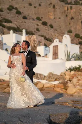 a bride and groom standing next to each other at Axiotheaton Villa Lydia in Pefki Rhodes