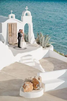 a bride and groom kissing in front of a church at Axiotheaton Villa Lydia in Pefki Rhodes