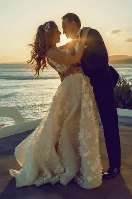 a bride and groom standing on the beach at Axiotheaton Villa Lydia in Pefki Rhodes