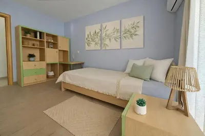 a small bedroom with a bed and a table at Alkion in Asgourou