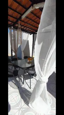 a room with a table and a tent at Louloudakis Apartment in Koskinou