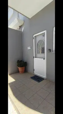 a room with a door and a potted plant at Louloudakis Apartment in Koskinou
