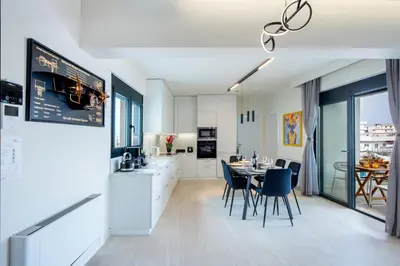 a kitchen and dining room with a table and chairs at SunHall City Maisonette in Rhodes Town