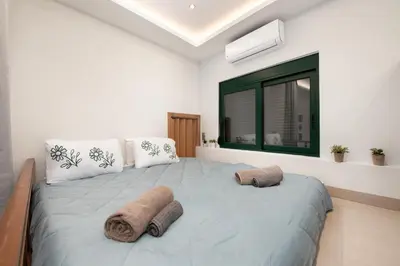 a bedroom with a large bed with towels on it at Loft 146 in Rhodes Town