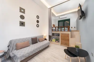 a living room with a couch and a table at Loft 146 in Rhodes Town