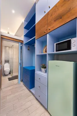 a bathroom with blue walls and a refrigerator at Loft 146 in Rhodes Town