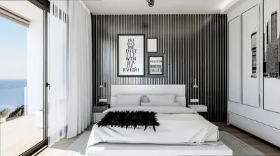 a bedroom with a white bed and a black wall at Villa Rafael in Lindos, Rhodos for 8gst in Líndos