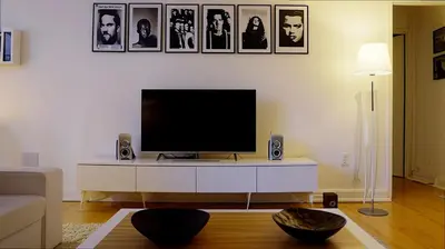 a living room with a flat screen tv on a white cabinet at Villa Rafael in Lindos, Rhodos for 8gst in Líndos