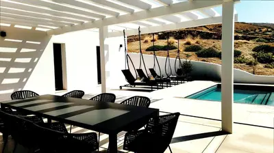 a patio with a table and chairs and a swimming pool at Villa Rafael in Lindos, Rhodos for 8gst in Líndos