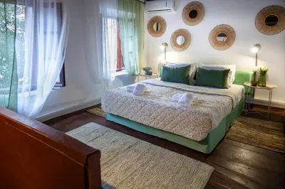 a bedroom with a bed and mirrors on the wall at St Nicholas traditional house in Rhodes Town