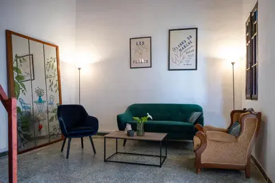 a living room with a green couch and two chairs at St Nicholas traditional house in Rhodes Town