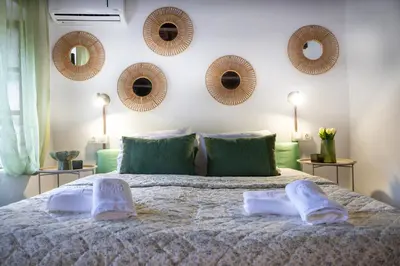 a bedroom with a large bed with mirrors on the wall at St Nicholas traditional house in Rhodes Town