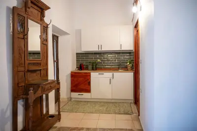 a small kitchen with white cabinets and a sink at St Nicholas traditional house in Rhodes Town