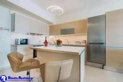 a kitchen with a stainless steel refrigerator and a counter at Rhodes Port Haven Suite in Rhodes Town