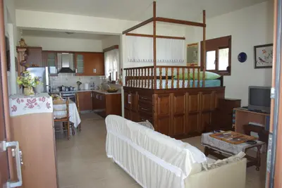 a kitchen with a couch and a table in a room at Mano's House in Monólithos