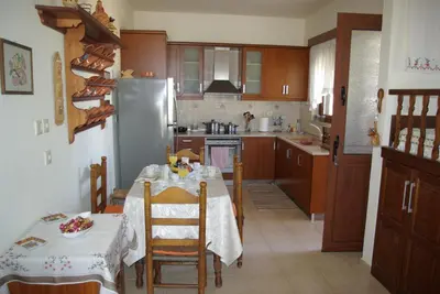 a kitchen with a table and a refrigerator at Mano's House in Monólithos