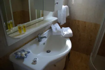 a bathroom with a sink and a mirror at Mano's House in Monólithos