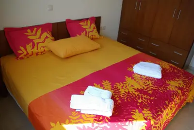a bedroom with a bed with towels on it at Mano's House in Monólithos