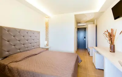 a bedroom with a large bed in a room at Casa Blue Sarantis in Faliraki
