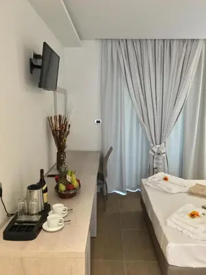 a hotel room with a bed and a table with a breakfast at Casa Blue Sarantis in Faliraki