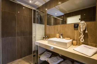 a bathroom with a sink and a mirror at Casa Blue Sarantis in Faliraki