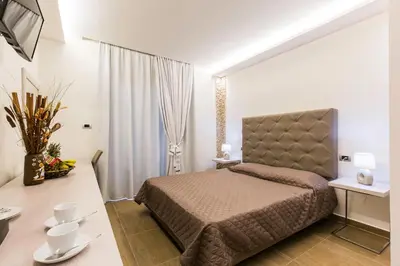 a bedroom with a bed and a desk and a television at Casa Blue Sarantis in Faliraki