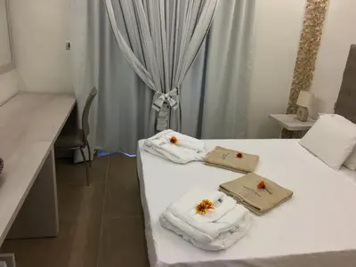 a hotel room with two beds with towels on them at Casa Blue Sarantis in Faliraki