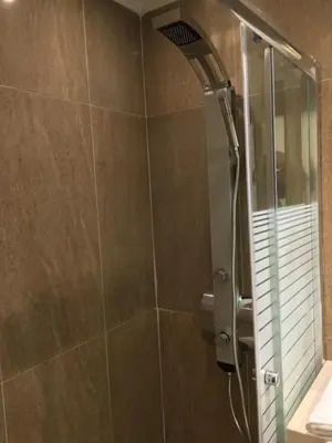 a bathroom with a shower with a glass door at Casa Blue Sarantis in Faliraki