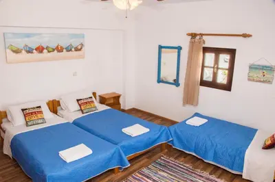 a room with two beds and a window at Jacks Studios in Líndos