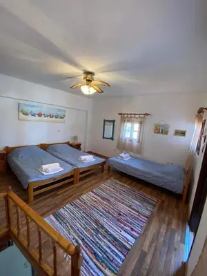 a living room with two beds and a rug at Jacks Studios in Líndos