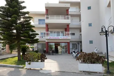 a building with a palm tree in front of it at Faliraki Dream Studios & Apartments in Faliraki