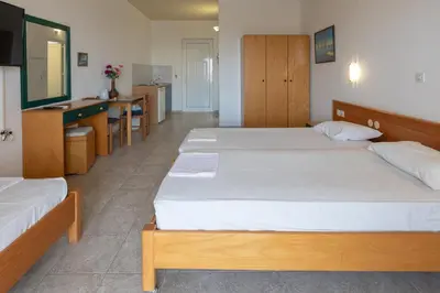 a hotel room with two beds and a kitchen at Faliraki Dream Studios & Apartments in Faliraki
