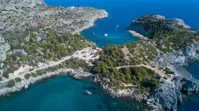 an aerial view of a island with blue water at Faliraki Dream Studios & Apartments in Faliraki
