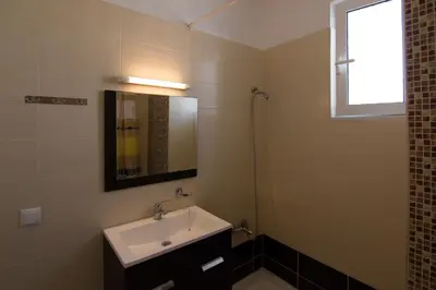 a bathroom with a sink and a mirror at Faliraki Dream Studios & Apartments in Faliraki