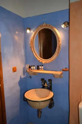 a bathroom with a sink and a mirror at Elafusa Luxury Apartment in Rhodes Town