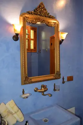 a bathroom with a mirror and a sink at Elafusa Luxury Apartment in Rhodes Town