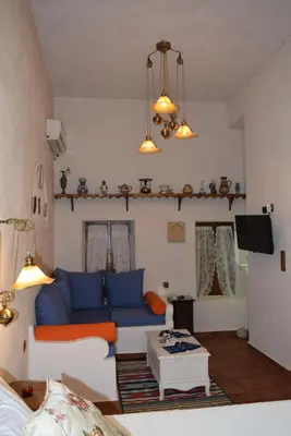 a living room with a blue couch and a table at Elafusa Luxury Apartment in Rhodes Town