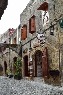 an old stone building on a cobblestone street at Elafusa Luxury Apartment in Rhodes Town