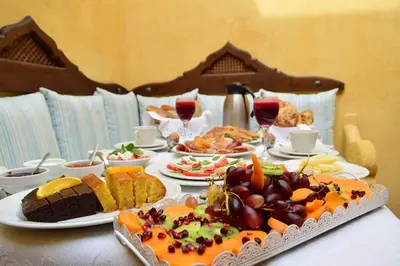 a table with plates of food on top of it at Elafusa Luxury Apartment in Rhodes Town