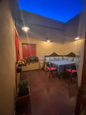 a room with a table and chairs and a blue light at Elafusa Luxury Apartment in Rhodes Town