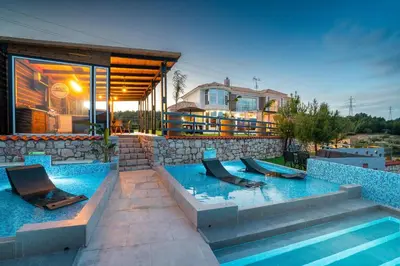 a swimming pool with two slides in a house at Paramithia Villa in Afantou