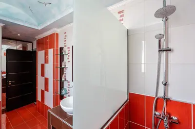 a bathroom with red and white tiles and a sink at Paramithia Villa in Afantou
