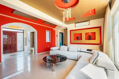 a living room with a couch and a table at Paramithia Villa in Afantou