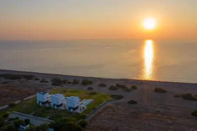 an aerial view of a sunset over the ocean at Albatross Beach Front Villas in Gennadi
