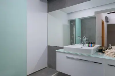 a bathroom with a white sink and a mirror at Albatross Beach Front Villas in Gennadi
