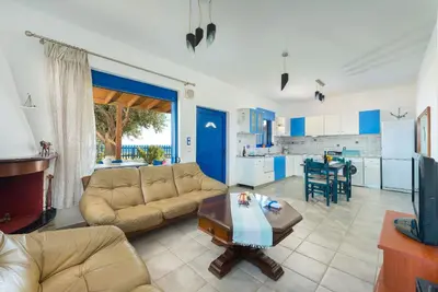 a living room with a couch and a table at Stegna House Sea View in Archangelos
